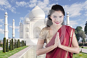 Indian woman with welcome gesture in Taj Mahal