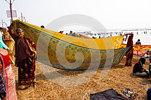 Indian women dry sari on the sun