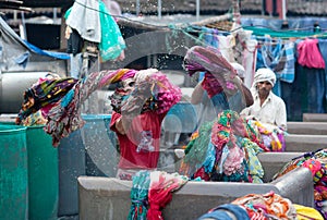 Indian workers washing clothes at Dhobi Ghat in downtown of Mumbai, Maharashtra, India