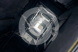 Indian yard well bottom up view to light on roof, narrow shaft yard with windows opposite each other