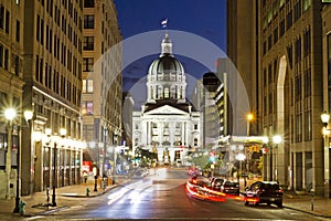 Indiana statehouse at night with busy streets and nightlife