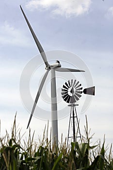 In Indiana, USA, near the town of Fowler, the old and new are seen together. A modern wind turbine used to generate electricity is