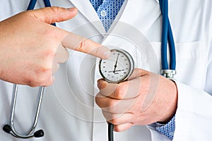 Indication of high blood pressure hypertension in patient concept photo. Doctor with stethoscope pointing by finger at level of