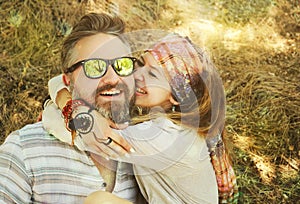 Indie style smiling couple, woman embracing man, hipster outfit, boho chic