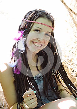 Indie style young woman with dreadlocks portrait, outdoor in autumn park