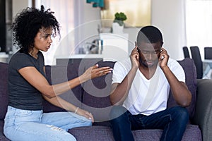 Indifferent black husband ignore pushy wife lecturing