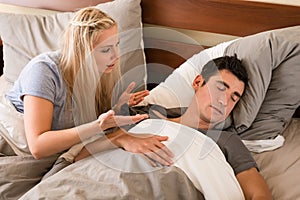 Indifferent man sleeping in bed next to his partner photo