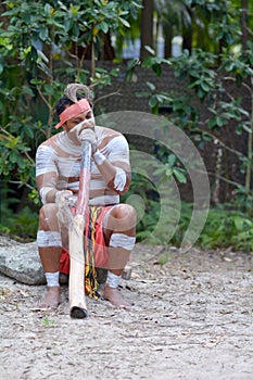 Indigenous Australian Man playing Aboriginal Music on Didgeridoo Instrument