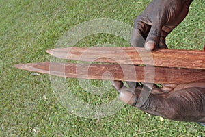 Indigenous Australians aboriginal craftman making a  a wooden Australian Aboriginal spear photo