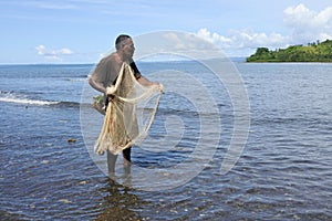 Indigenous Fijian fisherman fishing with a Fishing net in Fiji