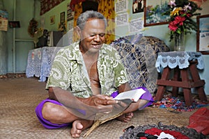 Indigenous Fijian man reads the bible in Fiji