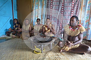 Indigenous Fijians men participate in traditional Kava Ceremony