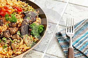 Indigenous Ghanaian, African-Caribian food Jollof Rice with tomato sauce, regional spices, chicken meat and offal