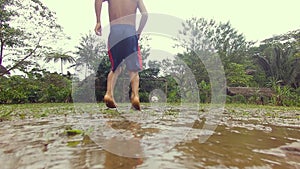 Indigenous Kids Playing Soccer In The Rain In The Amazon Rainforest