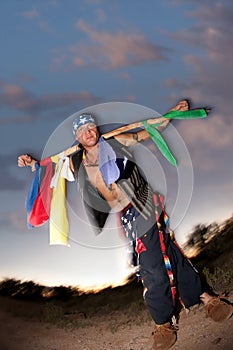 Indigenous man with ceremonial pole