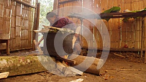 Indigenous old woman making chicha drink