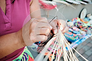 Indigenous Woman Weaving Coaster At Street Market Stall