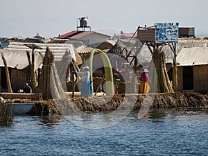 Indigenous women in colorful traditional dresses on Uros Floating reed Islands on Lake Titicaca Puno Peru South America