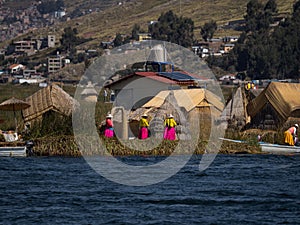 Indigenous women in colorful traditional dresses on Uros Floating reed Islands on Lake Titicaca Puno Peru South America