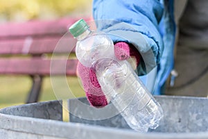 Indigent senior woman scrounging through a bin