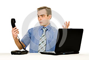 Indignant man working on laptop. Isolated on whi photo