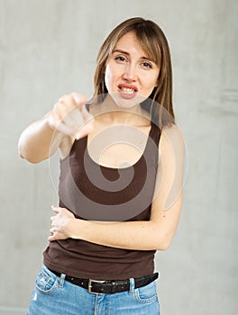 Indignant young woman gesturing in studio