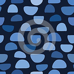 Indigo blue abstract paper cut dotty pebbles. Vector pattern seamless background. Hand drawn textured style. Half dot rock shapes