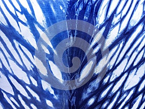 Indigo blue fabric tie dye pattern background.