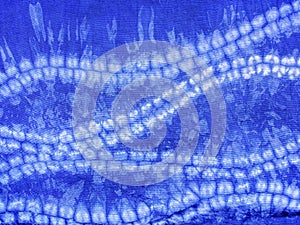 Indigo blue fabric tie dye pattern background.