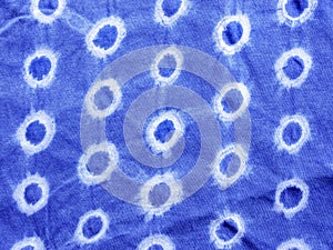 Indigo blue fabric tie dye pattern background.