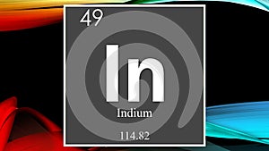 Indium chemical element symbol on dark colored abstract background
