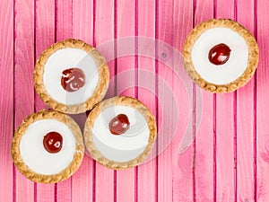 Individual Bakewell Tarts On A Pink Background