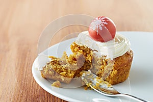 Individual bitten carrot cake on a dish