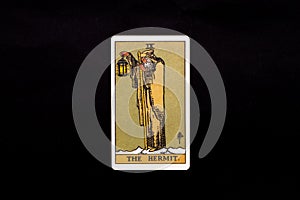 An individual major arcana tarot card isolated on black background. The Hermit.