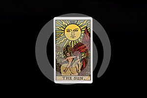 An individual major arcana tarot card isolated on black background. The Sun.