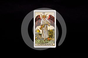 An individual major arcana tarot card isolated on black background. Temperance. photo