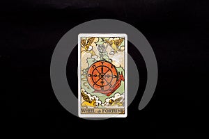 An individual major arcana tarot card isolated on black background. Wheel of fortune.