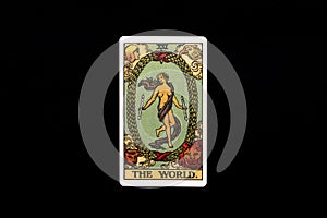 An individual major arcana tarot card isolated on black background. The World. photo