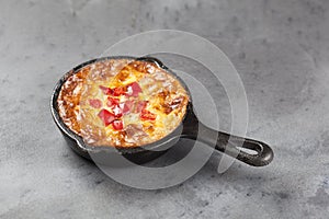 An individual mini quiche in a pan