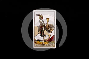 An individual minor arcana tarot card isolated on black background. Knight of cups.