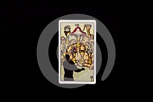 An individual minor arcana tarot card isolated on black background. Seven of cups.