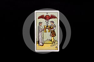 An individual minor arcana tarot card isolated on black background. Two of cups.