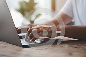 An individual is typing on a keyboard laptop showing a hologram interface to a member login, a businessman is going to access the