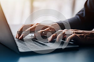 An individual is typing on a keyboard laptop showing a hologram interface to a member login, a businessman is going to access the