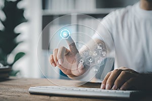 An individual is typing on a keyboard showing a hologram interface to a member login, a businessman is going to access the company