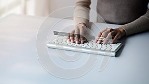 An individual is typing on a laptop keyboard showing a hologram interface to a member login, a businessman is going to access the