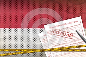 Indonesia flag and Health insurance claim form with covid-19 stamp. Coronavirus or 2019-nCov virus concept