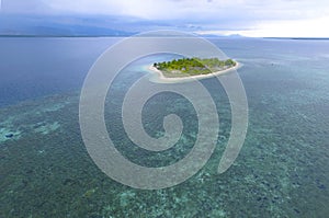 Aerial Isolated island, tropical island with blue transparent water photo