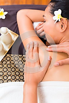 Indonesian Asian woman at wellness spa massage