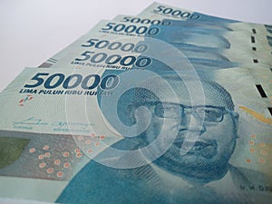 Indonesian bank notes. 50000 rupiah banknotes. Blue banknotes. White isolated background . Means of payment